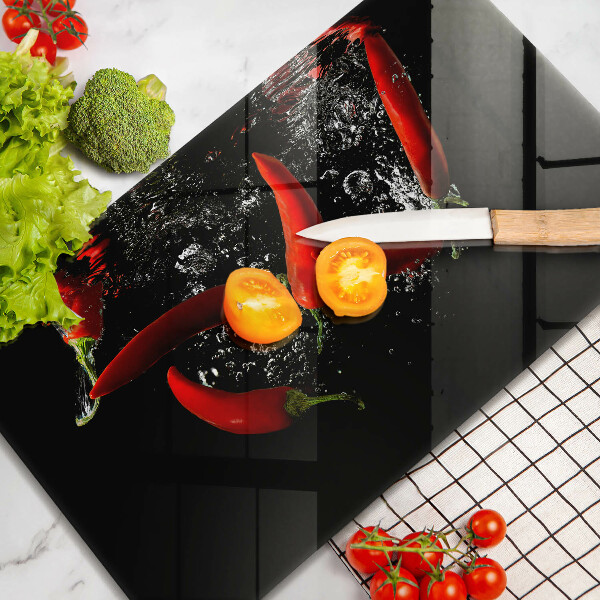 Chopping board glass Chili peppers in water