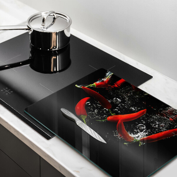 Chopping board glass Chili peppers in water
