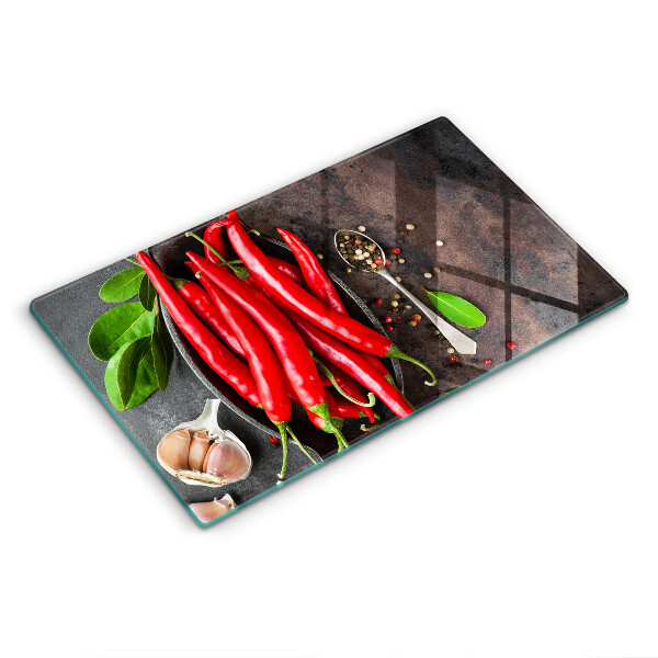 Chopping board glass Red chili peppers