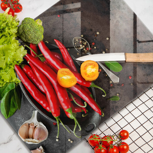 Chopping board glass Red chili peppers