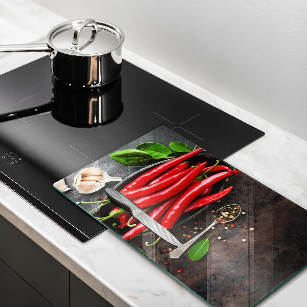 Chopping board glass Red chili peppers