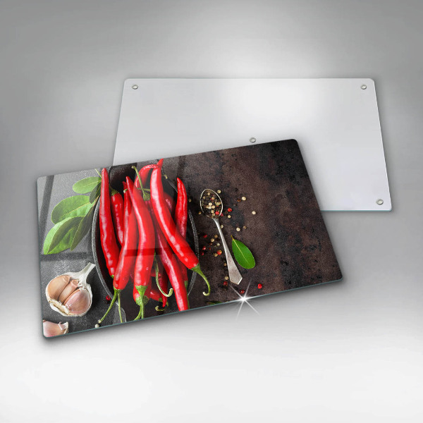 Chopping board glass Red chili peppers