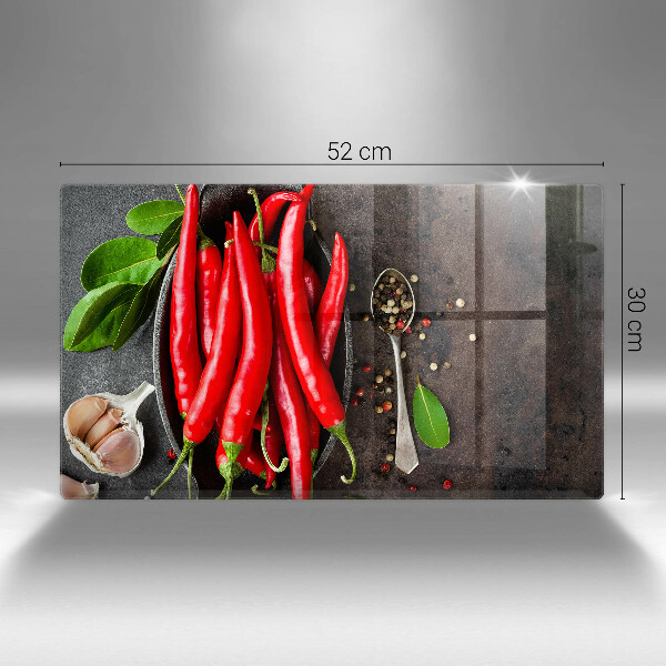 Chopping board glass Red chili peppers
