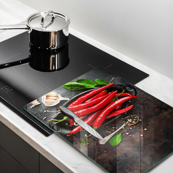Chopping board glass Red chili peppers