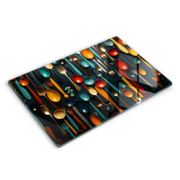 Chopping board glass Colorful spoons and forks