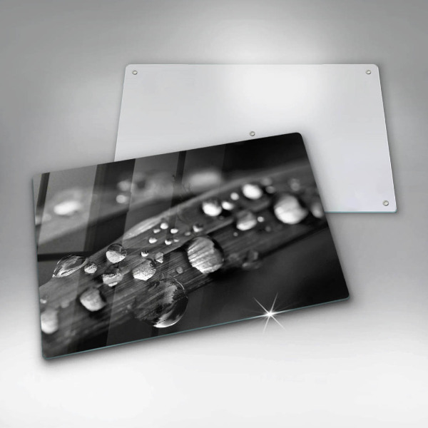 Chopping board glass Drops of dew on the leaves