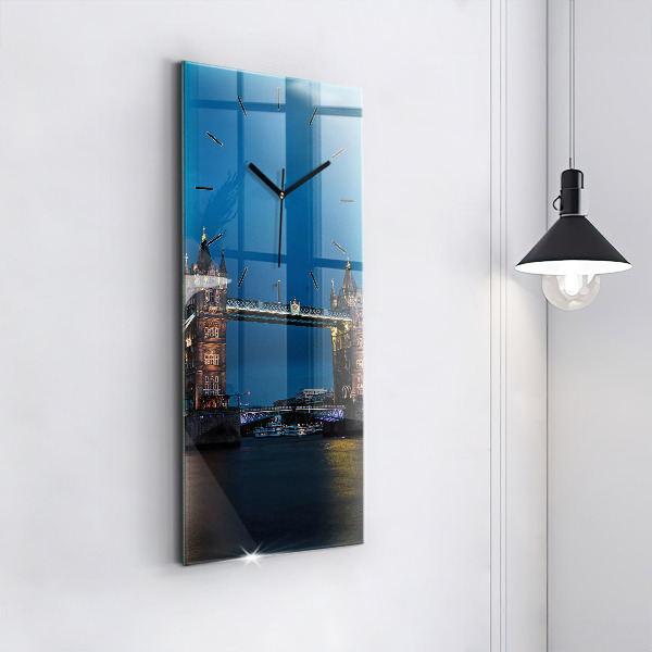 Modern vertical wall clock Tower Bridge London at night