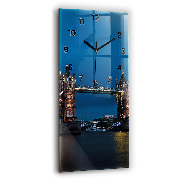 Modern vertical wall clock Tower Bridge London at night