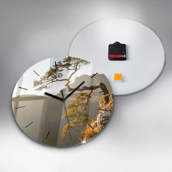 Round glass clock A tree in the mountains