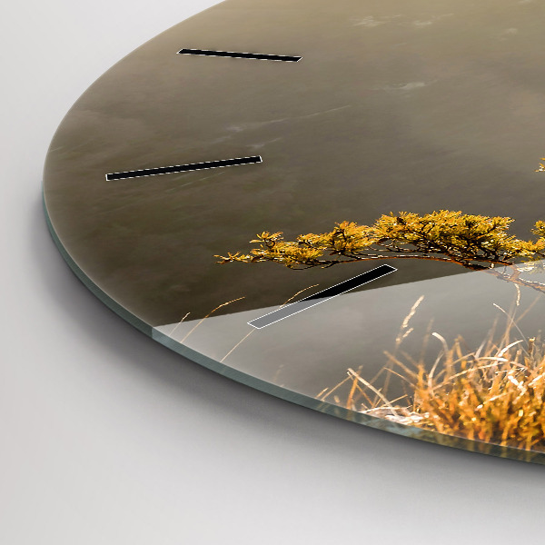 Round glass clock A tree in the mountains