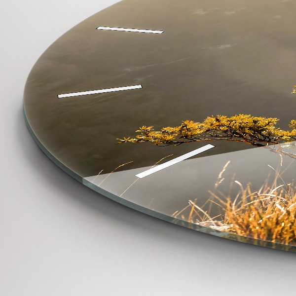 Round glass clock A tree in the mountains