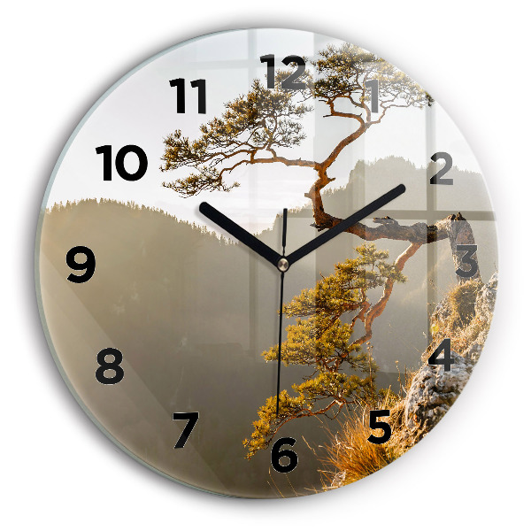 Round glass clock A tree in the mountains