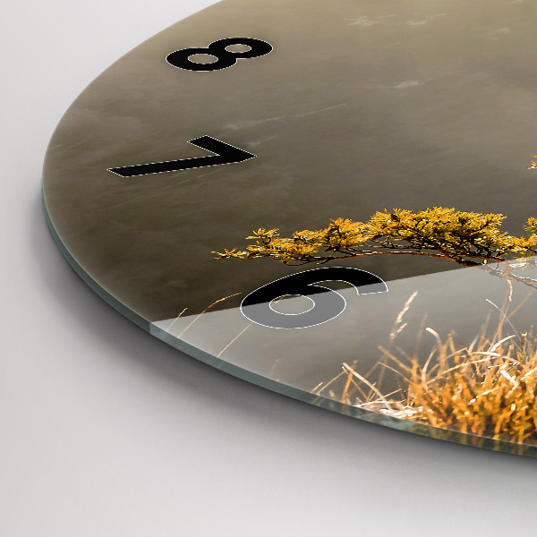 Round glass clock A tree in the mountains
