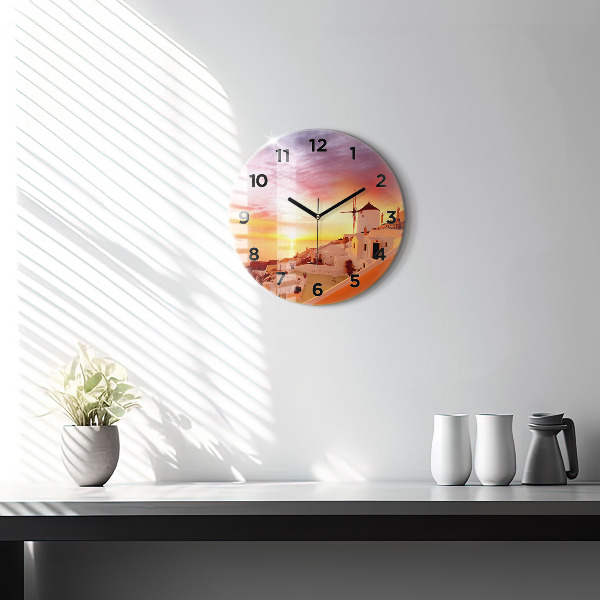 Round glass clock Old windmill in Santorini