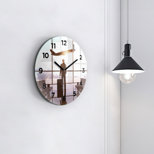 Round glass clock Man at the airport