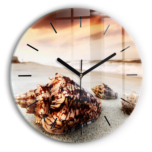 Round glass clock A shell on the beach