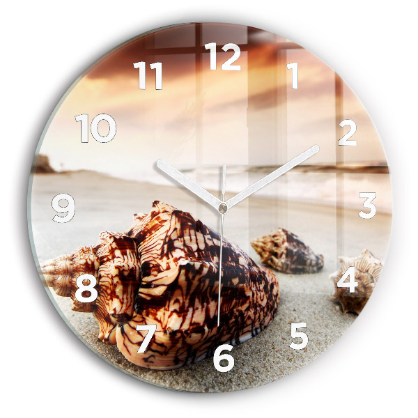 Round glass clock A shell on the beach