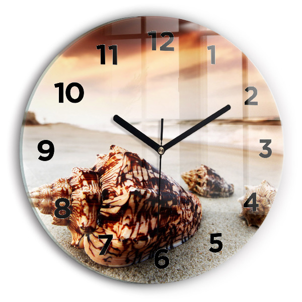 Round glass clock A shell on the beach