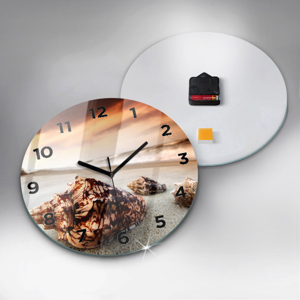 Round glass clock A shell on the beach
