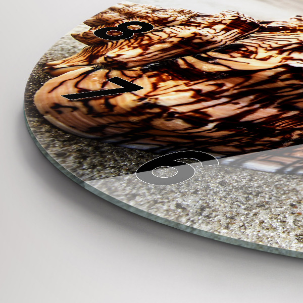 Round glass clock A shell on the beach