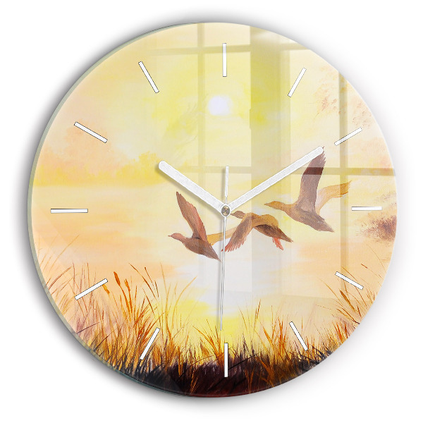 Round glass clock Cranes at sunset