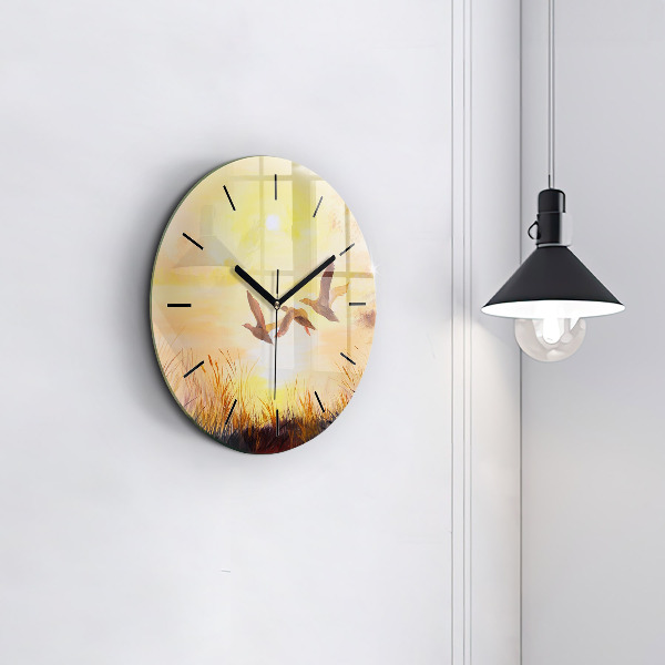 Round glass clock Cranes at sunset