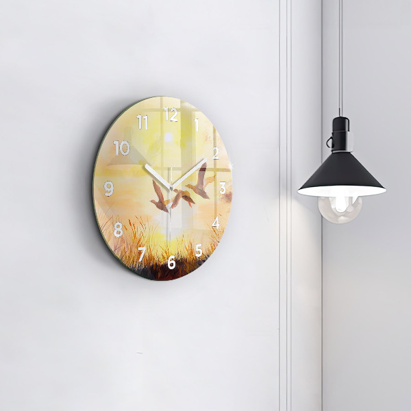 Round glass clock Cranes at sunset