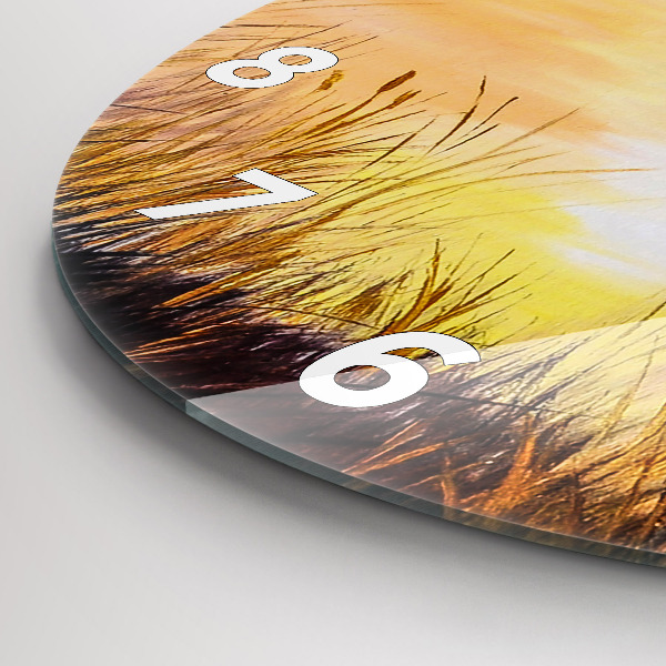 Round glass clock Cranes at sunset