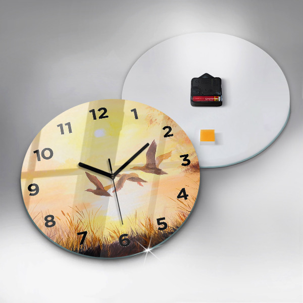 Round glass clock Cranes at sunset