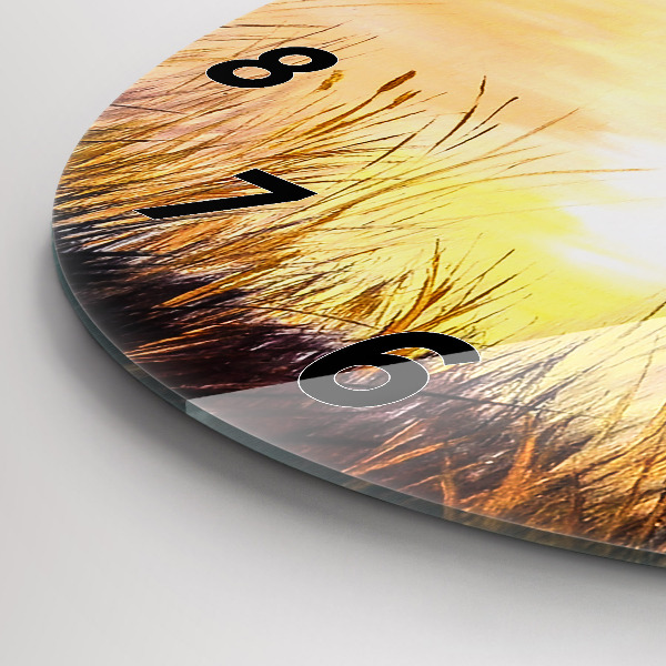 Round glass clock Cranes at sunset