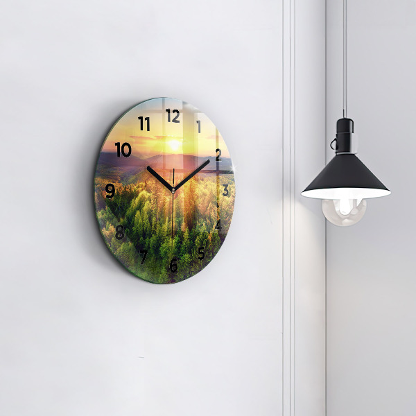 Round glass clock Sunset over the hills