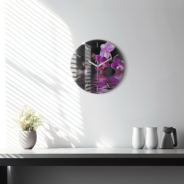 Round glass clock Orchid flower on the water