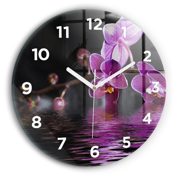 Round glass clock Orchid flower on the water