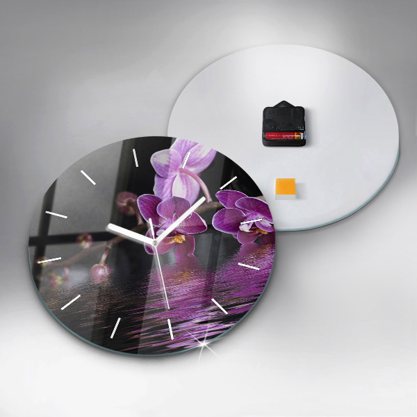 Round glass clock Orchid flower on the water