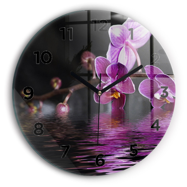 Round glass clock Orchid flower on the water