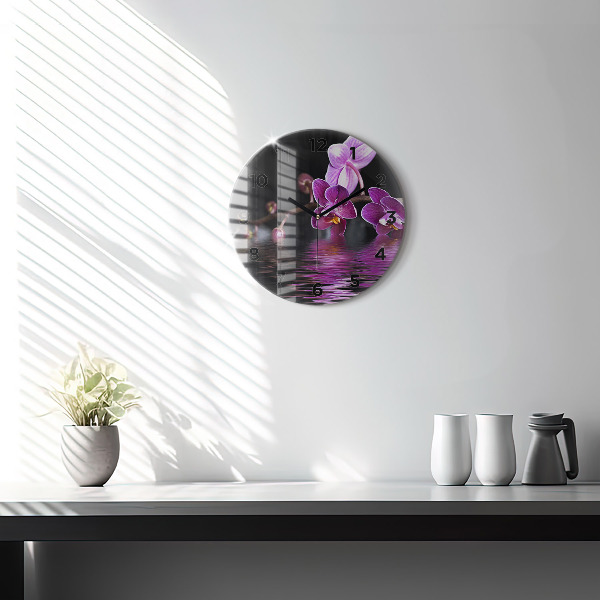 Round glass clock Orchid flower on the water