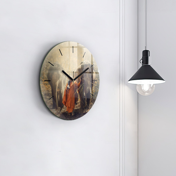 Round glass clock Monk leading elephants