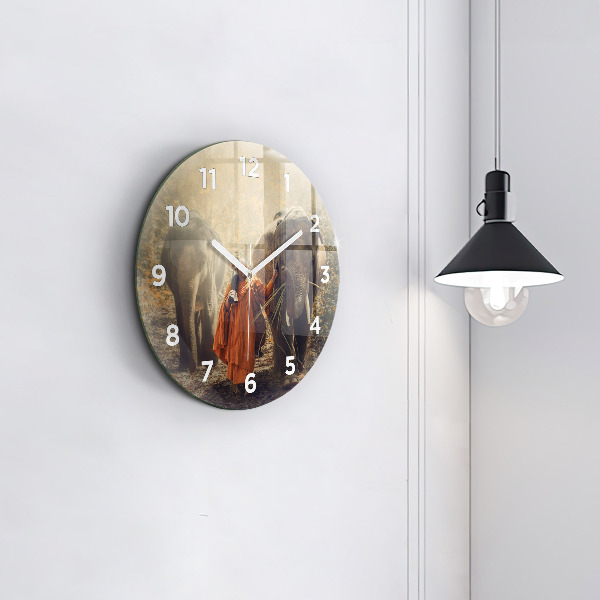 Round glass clock Monk leading elephants