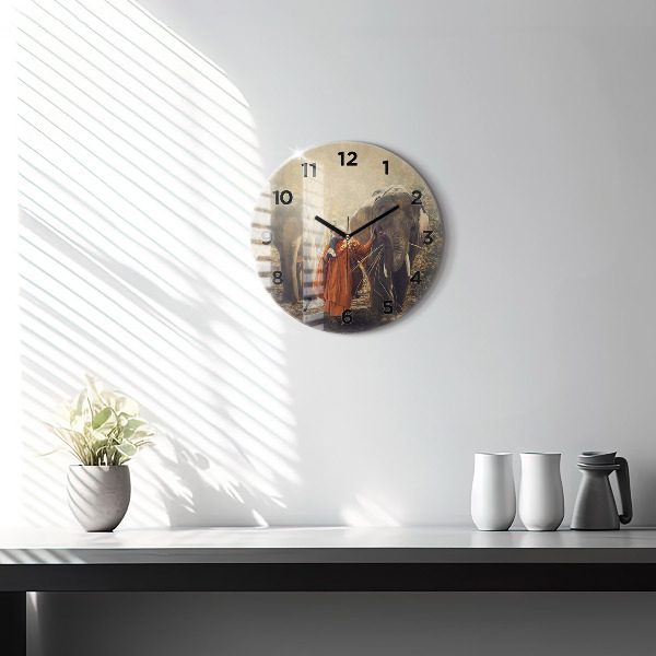 Round glass clock Monk leading elephants