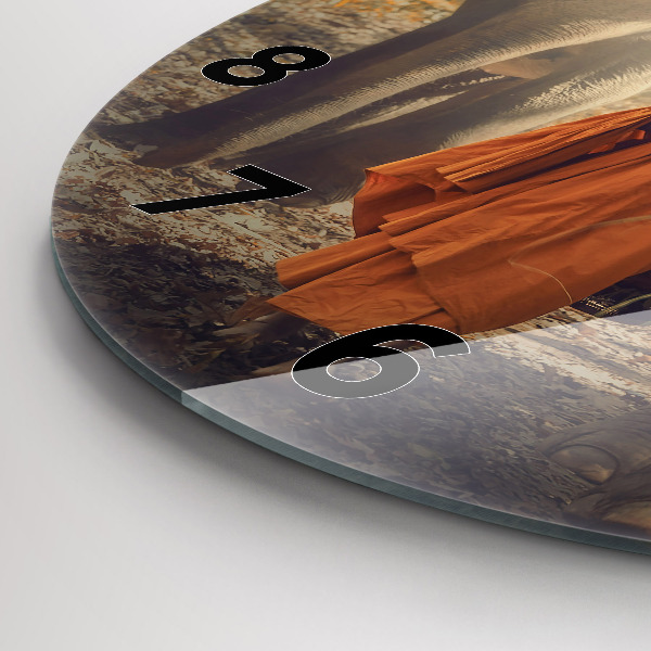Round glass clock Monk leading elephants