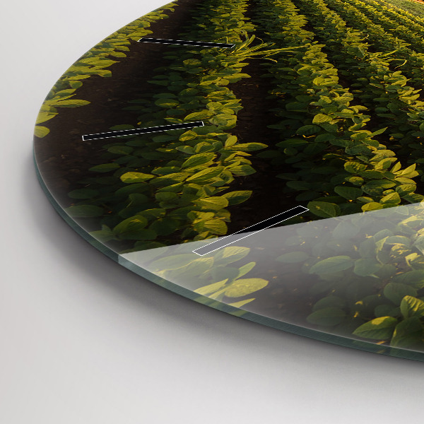 Round glass clock Tractor in a farm field