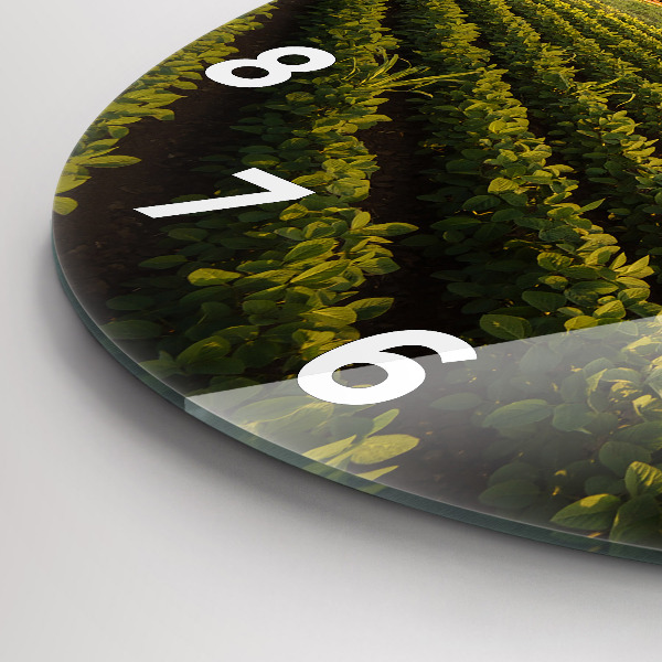 Round glass clock Tractor in a farm field