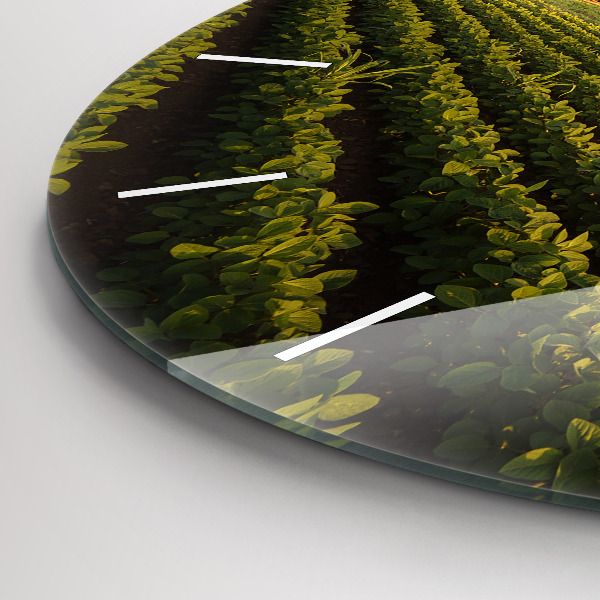 Round glass clock Tractor in a farm field