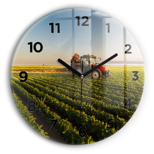 Round glass clock Tractor in a farm field