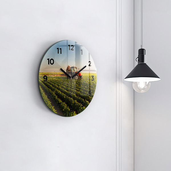 Round glass clock Tractor in a farm field