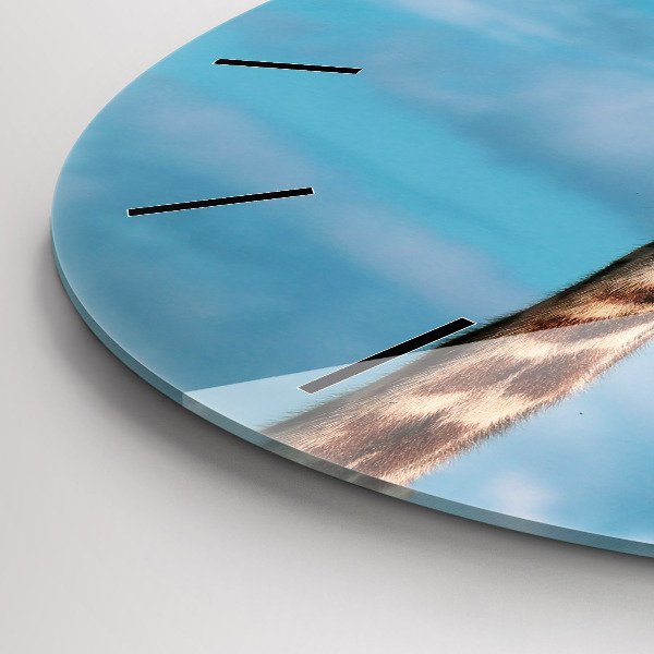 Round glass clock Giraffe head against the sky