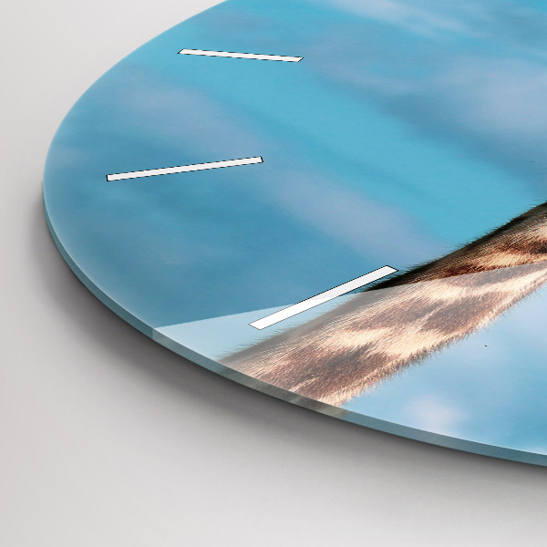 Round glass clock Giraffe head against the sky