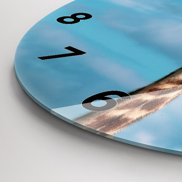 Round glass clock Giraffe head against the sky