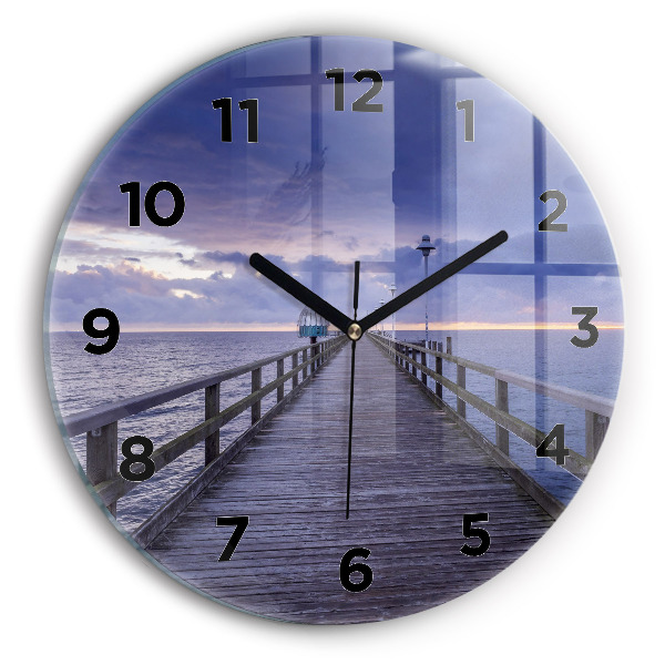 Round glass clock Pier on the Baltic Sea