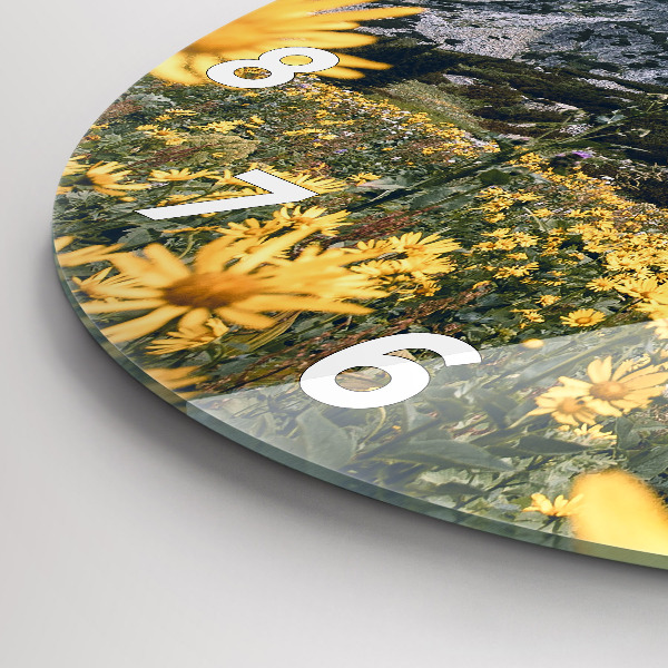 Round glass clock Meadow flowers in the mountains